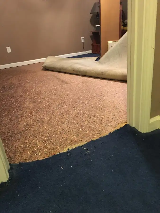 Carpet pad removal revealing water damage during Water Mitigation Services in Childress
